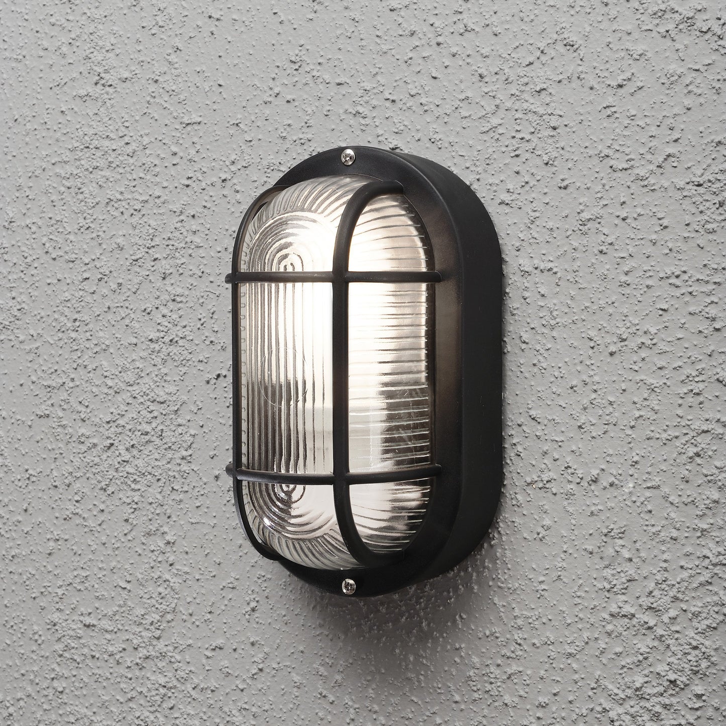 Konstsmide 7650-750 Elmas Bulk Head Outdoor Wall Light Mains Powered / W: 12cm D: 10.5cm H: 20cm / 1 x 40 W E27 Max Wall Lamp / Clear Ribbed Glass / Plastic / IP44 / Outside Light Black